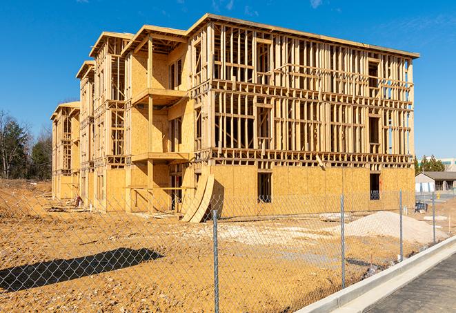 a close-up of temporary chain link fences enclosing a job site, signaling progress in the project's development in Cold Springs